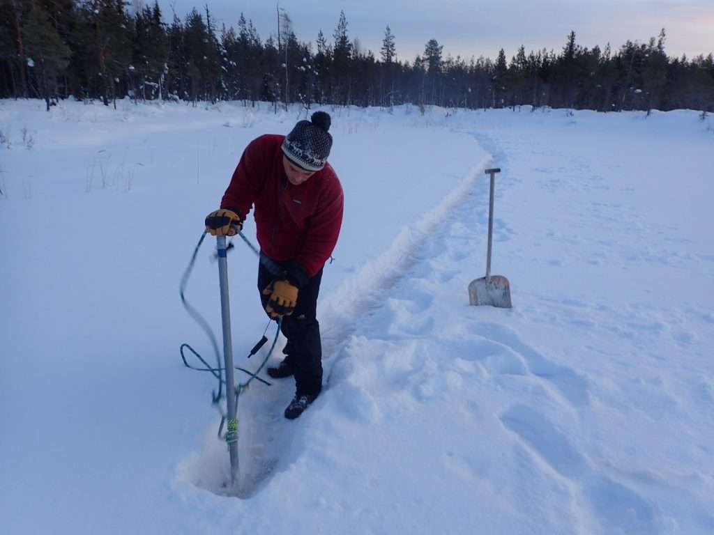 Digging out the snow on a frozen lake and whacking the ice hard with a pointed steel Toog several times. Scary business, but essential for expeditions The ropes and prussick are an adjustable carry sling for across the back. Jeez it was cold....The things hanging off my wrists are ice awls: spikes in case you fall through, you thrust them into the ice and haul yourself out...not sure what happens after that...hyperthermia probably unless someone’s with you...